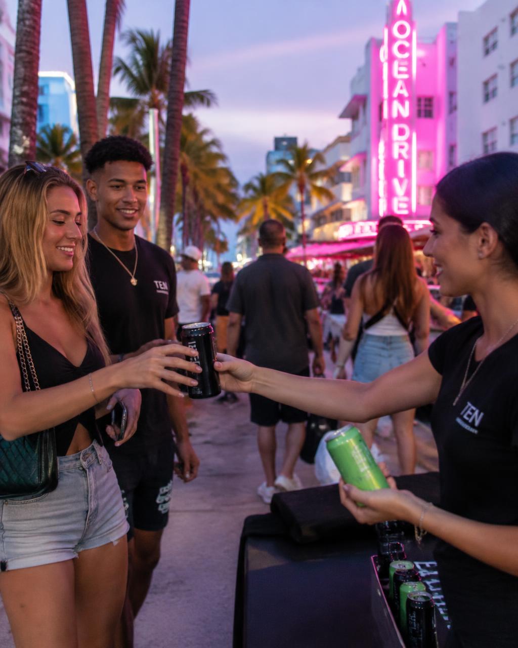 Street team handing LVF cans to fans in Miami